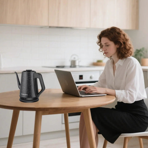 Woman using laptop near Electric Kettle With 1L Capacity And Gooseneck Spout, 1000W Quick Boil In 3 Minutes, 304 Stainless Steel Tea And Pour Over Coffee Kettle For Office Travel Kitchen, Auto Shut Off, BPA Free, Black Star Design on table.