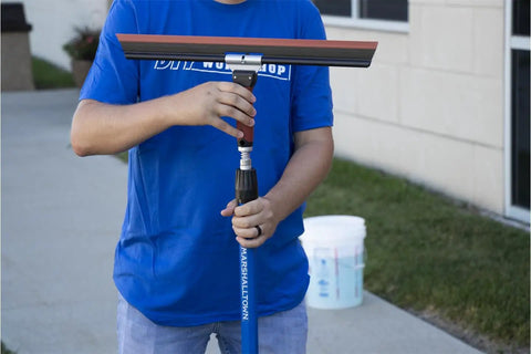 Person using Adjustable Squeegee Trowel With DuraSoft Handle For Drywall And Plastering 35 Degree Adjustable Pitch For Ceilings And Tight Corners Knockdown Tool AKD18 outdoors