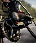 Cyclist using Uno Single-Sided Power Meter Pedal Bundle With 2 Pairs Black Cleats, Cleaning Cloth, And Multi-Tool Kit, close-up.