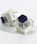 Kailh 35pcs Box Navy Clicky Mechanical Keyboard Switches, 3-Pin 95gf Pre-Lubed Heavy Force Switches For Custom Keyboards, Bold Tactile Click With Smooth Actuation Right Out Of The Box. close-up of two blue and clear 3-pin keyboard switches
