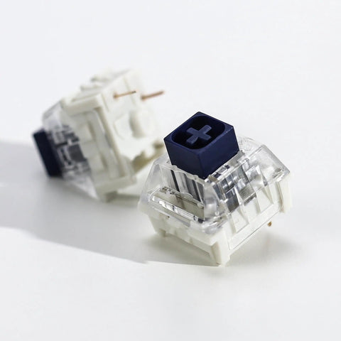 Kailh 35pcs Box Navy Clicky Mechanical Keyboard Switches, 3-Pin 95gf Pre-Lubed Heavy Force Switches For Custom Keyboards, Bold Tactile Click With Smooth Actuation Right Out Of The Box. close-up of two blue and clear 3-pin keyboard switches