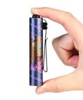 Rider RX LED Flashlight, 650 Lumen Rechargeable AA EDC Pocket Light held in hand, showing compact size and design