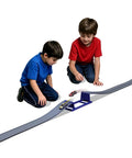 Children playing with Flexible Dual Lane Race Track With Jump Ramp Toy For Kids, 13 Feet Of Action, featuring elevated jump track.