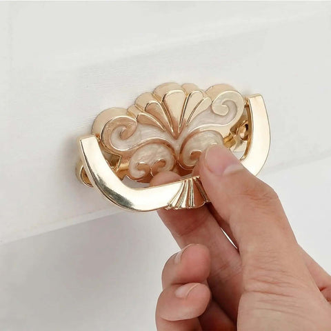 Antique Gold Concealed Flat Pull Cabinet Handles Set Of 2 No Drill Required, close-up of hand holding ornate pull with cream enamel accent