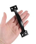 Hand holding a black 6-inch cast iron door handle. 4 Pack 6 Inch Cabinet Door Handles Vintage Barn Door Pulls Drawer Pulls Gate Handle Metal Gate Pulls.