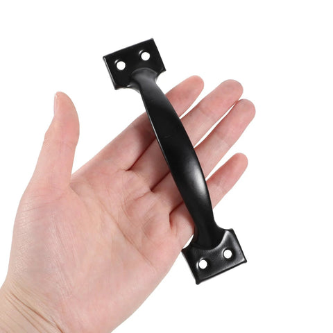 Hand holding a black 6-inch cast iron door handle. 4 Pack 6 Inch Cabinet Door Handles Vintage Barn Door Pulls Drawer Pulls Gate Handle Metal Gate Pulls.
