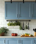 Stainless Steel Cabinet Handles With Three Inch Hole Spacing Drawer Pulls for cabinets in kitchen setting, matte black finish, on blue cabinets.