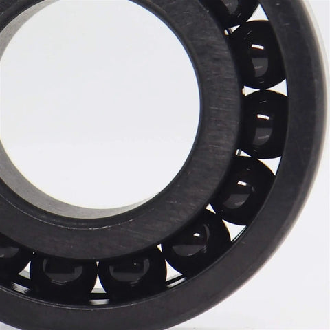 Close-up view of Dead Serious High Temperature Chrome Steel Full Ball Bearings 50X80X10mm TB16010 with black manganese phosphate coating.