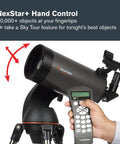 Person holding hand controller with NexStar 127SLT Computerized Telescope With SkyAlign Auto Finder on tripod base.