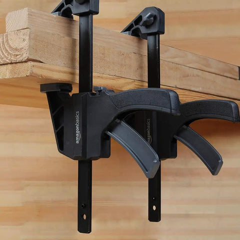 Six Piece Easy To Use One Handed Trigger Clamp Set With Four Inch And Six Inch Clamps In Black And Grey Installed on Wooden Beam