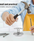 Close-up of a hand using a hammer and nail with a stainless steel adjustable table leg on a table