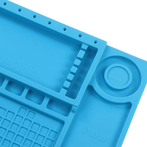 Close-up of blue Pro Grade Silicone Electronic Repair Mat With High Temperature Resistance Antistatic Soldering Pad with slots