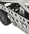 Close-up of wheel and metal frame from Stainless Steel Model Car Kit For Adults A Do It Yourself 3D Puzzle And Mechanical Engineering Toy