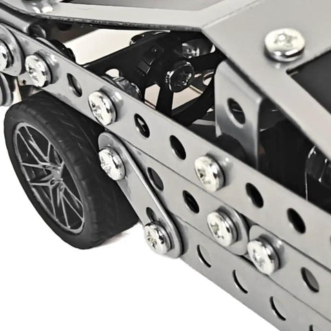 Close-up of wheel and metal frame from Stainless Steel Model Car Kit For Adults A Do It Yourself 3D Puzzle And Mechanical Engineering Toy