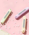 2 In 1 Needle Threader And Seam Ripper Set For Quick Threading Portable And Durable Sewing Tool, pastel colors on pink surface