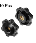 Pair of black Ten Pack Star Knobs That Grip Like A Boss Quarter Inch Twenty Female Thread, 32mm Head, with brass insert