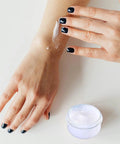 Applying lotion from Five Pack 10ml Travel Containers Set For Creams, Lotions, And Makeup, Ultra Compact Lightweight Travel Jars