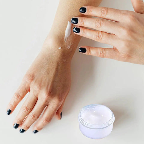 Applying lotion from Five Pack 10ml Travel Containers Set For Creams, Lotions, And Makeup, Ultra Compact Lightweight Travel Jars