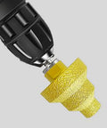 Diamond brazed step drill bit, gold color, mounted in drill chuck; suitable for concrete, tile and marble