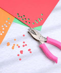 Dual Size Circle Hole Punch With One Quarter Inch And One Eighth Inch Holes For Paper Crafts And Scrapbooking shown with paper cutouts