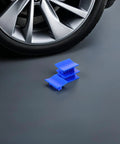 4 Piece Auto Dent Repair Kit With Plastic Puller Tabs next to car wheel for easy dent removal on most cars