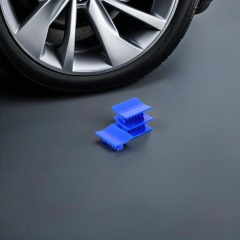 4 Piece Auto Dent Repair Kit With Plastic Puller Tabs next to car wheel for easy dent removal on most cars