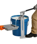 Heavy Duty Manual Loading Pump For Thick Paste And Liquid Transfer With Long Handle, transferring paint from blue bucket to tray.
