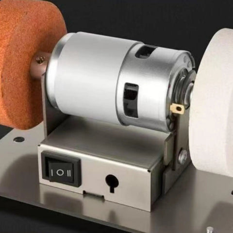 Close-up of Badass Compact Bench Grinder With Dual Wheel Grit Setup showing steel body, motor housing, and toggle switch.