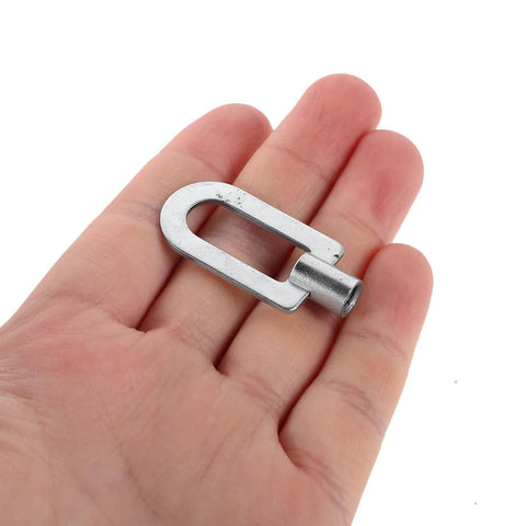 Close-up of a hand holding a piece from the Three-Piece Dent Puller Ring Kit for Auto Body and Sheet Metal Repair, Aluminum Construction.