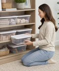 Woman organizing Clear Plastic Storage Bins With White Snap On Lids Set Of Ten Six Quart Capacity securely in a shelf.