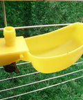 Top Tier Auto Fill Quail Water Cups 12 Pack Yellow Clip On Cage Drinkers for Pigeons showing a yellow plastic drinker attached to a cage.