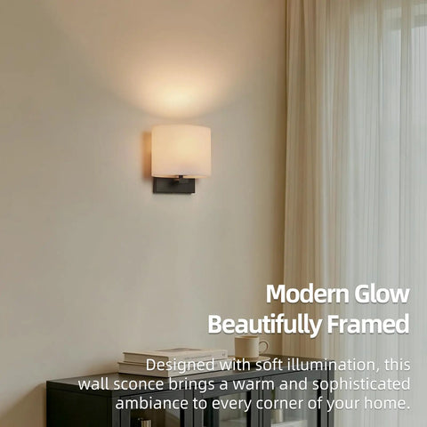 AuroraSpher Indoor Hardwired Modern Milky White Acrylic Black Wall Sconce, softly illuminated on a wall, enhancing the room's ambiance.