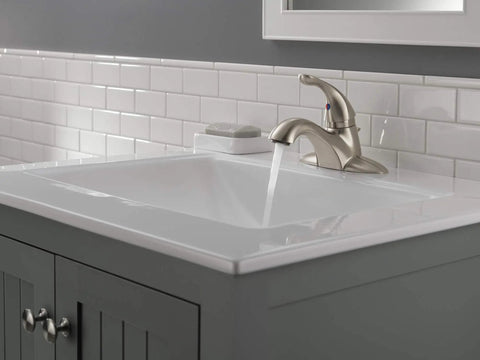Classic Single Handle Bathroom Faucet With Stainless Centerset Design Easy No Fuss Install on a white sink with flowing water