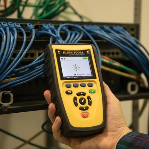 Hand holding Klein Scout Pro tester near network cables, Get Fast Easy Test And Map Up To Eight Network Locations In One Step.