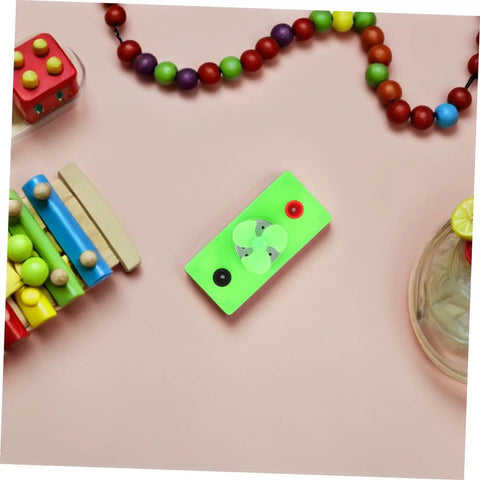Mini Solar Powered DC Motor For Science Experiments And Hands On DIY Projects on a desk with colorful beads