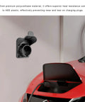 Gotta Get Your Cord Secure With This Electric Vehicle Charger Holder For SAE J1772 Stations mounted on a wall with a red car.