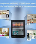Compact Upright Mini Freezer Featuring A Sleek Black Glass Door With Energy Efficient Cooling That Runs Dead Quiet At Twenty Eight Decibels Ideal For Dorms Offices Or Small Bedrooms With Plug And Play Design in various settings.