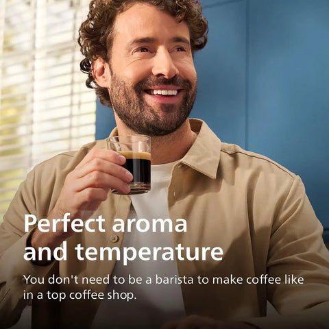 Man enjoying coffee from a glass, highlighting the Fully Automatic Espresso Coffee Maker With LatteGo Milk Frother And Ceramic Grinder For Smooth Daily Brewing At Home.