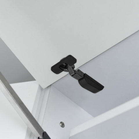 Slick Soft Close Concealed Cabinet Door Hinge With Silent Damping for Kitchen Cabinets mounted on white cabinet door, side view.