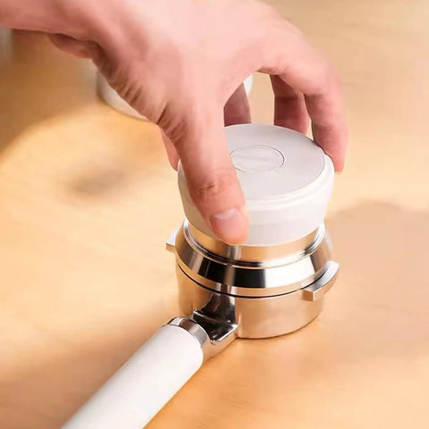 Top Shelf Hella Smooth 58Mm Stainless Steel Espresso Tamper Set With Spring Loaded Impact Hammer held over portafilter.