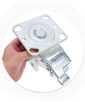 Rugged Steel Swivel Caster Bracket With Locking Brake And Four Inch Wheels For Heavy Machinery showing a close-up hand-held view.