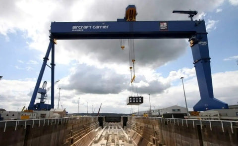 Industrial crane with hoist system over shipping dock, demonstrates use with Hoist Crane Wireless Pro Grade Remote Control Transmitter Kit.