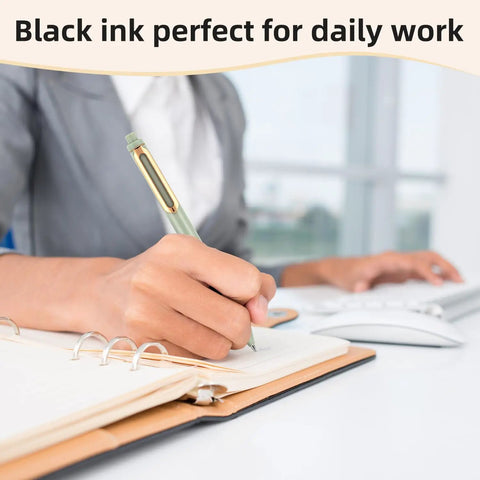 Person using 5 Pack Gel Pens 0.5mm Retractable Quick Dry Black Ink Fine Point Rolling Ball Gel Pens For Smooth Writing No Bleed Go To Journaling Note Taking Home School Office on notebook next to computer in an office setting.