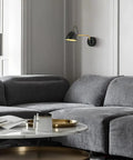 Swing Arm Wall Sconce With Touch Control Dimmable 10 To 100 Percent And 3 Color Temperatures 3000K 4500K 6000K Aluminum Brushed Nickel LED Reading Wall Lamp Hard Wired For Living Room And Bedroom installed in a living room above a grey sofa