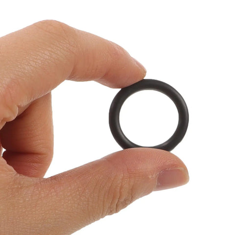 Hand holding a black rubber retaining ring, part of Premium 50 Pc Rubber Retaining Rings For Wrench Socket Pins That Lock Screws Tight.