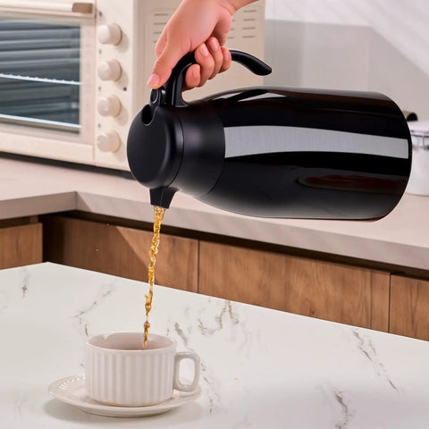 Pouring coffee from Keep Coffee Hot All Day With This Double Walled Vacuum Insulated Carafe 56 Ounce Thermal Urn, black