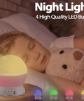 Child sleeping with plush toy beside Star Projector Night Light For Girls And Kids Room Rotating Night Light With 8 Color Changing