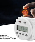Oumefar 16A Digital Timer Switch With Lcd Display Cycle Countdown Control For Irrigation Drying Ventilation And Industrial Electrical Applications, showing a hand activating the timer.