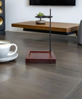 Top Shelf Wood Coffee Dripper Stand Built Tough With Stainless Base straight up on a table next to a coffee cup.