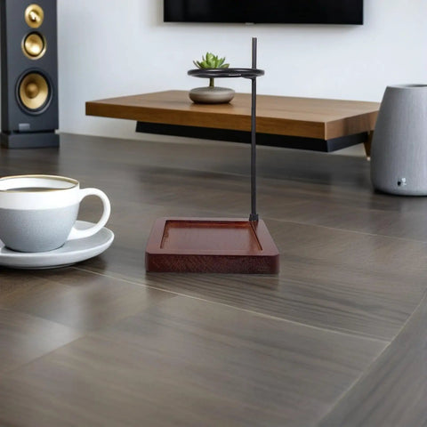 Top Shelf Wood Coffee Dripper Stand Built Tough With Stainless Base straight up on a table next to a coffee cup.